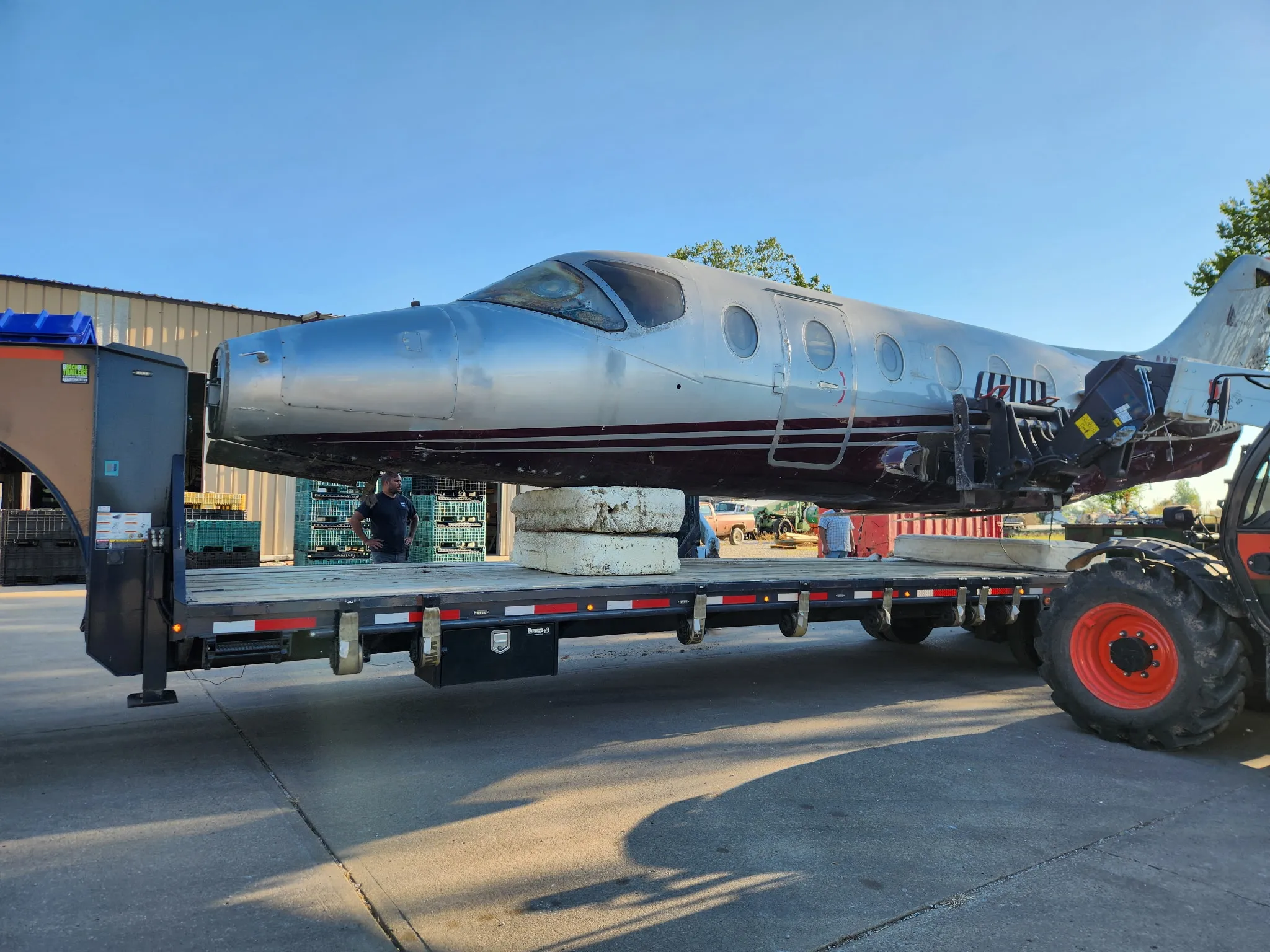 The Litachok aircraft fuselage secured on a trailer during transport.